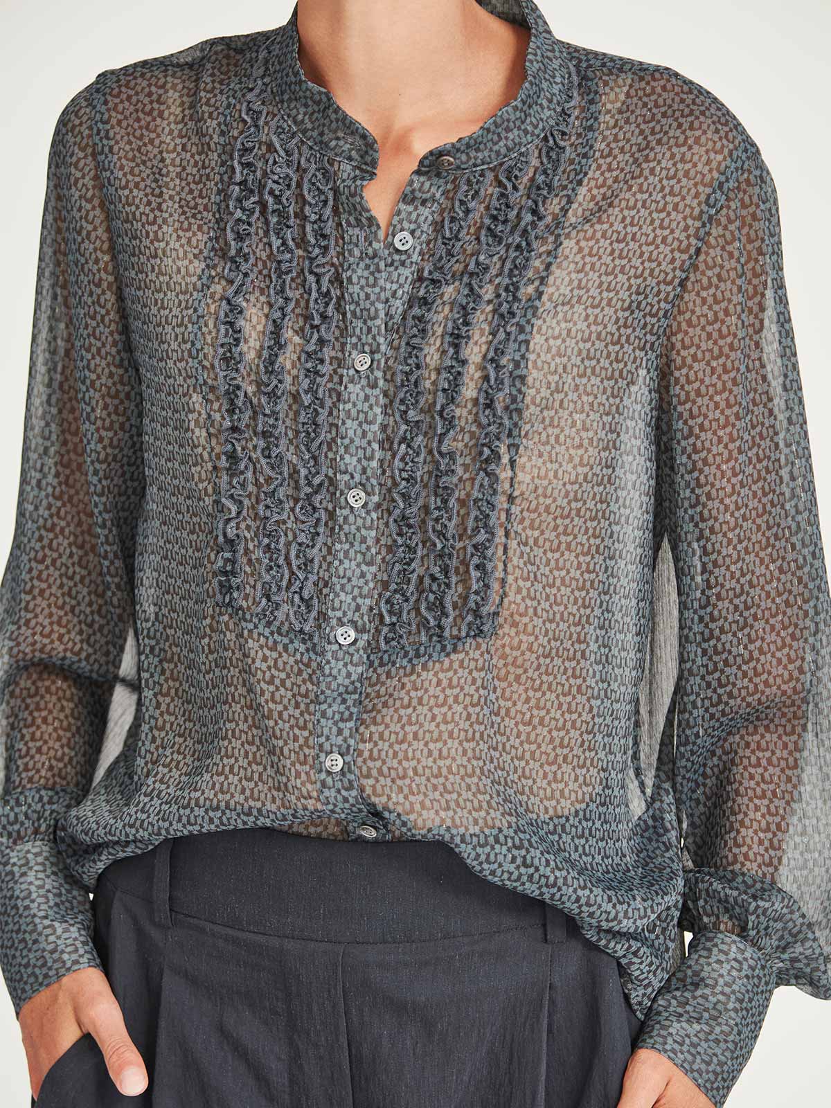 Close-up of the delicate ruffle trim bust and Mandarin collar detail of the Caroline Sills Dauphine Blouse in navy print.