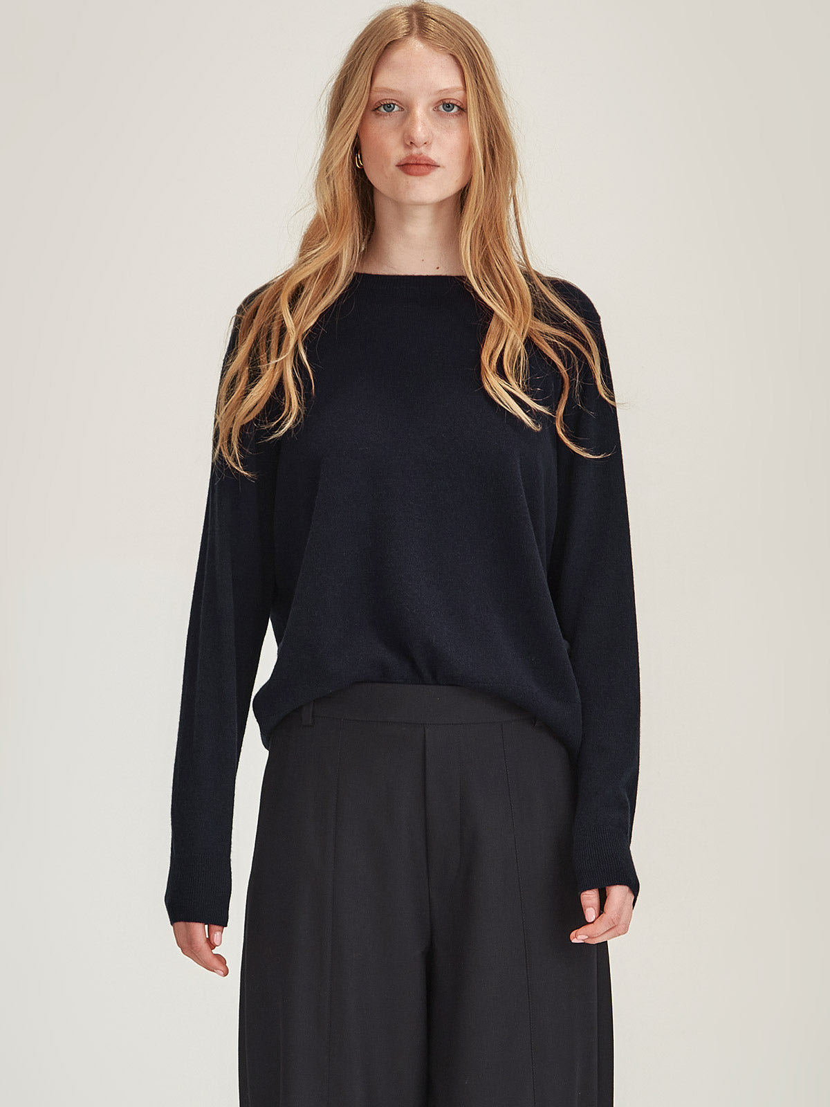 Close up of woman wearing Caroline Sills luxe Eleanor crew neck Cashmere Sweater in French Navy colour