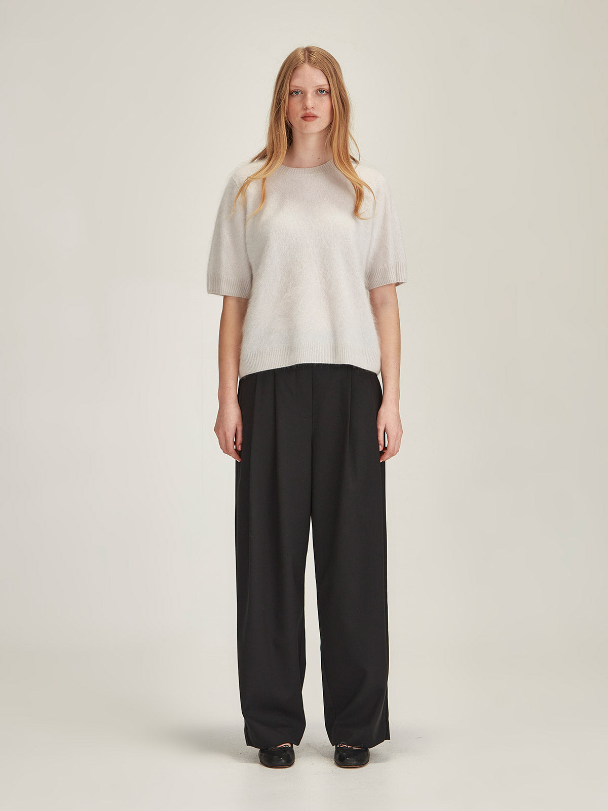 Woman wearing Caroline Sills merino wool Ashley Pleat Pant with Brushed Cashmere Tee in Vapour against white background