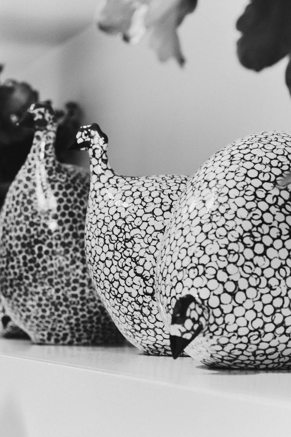 Assorted hand-painted ceramic pintades by Les Céramiques de Lussan, displayed in a black and white image.