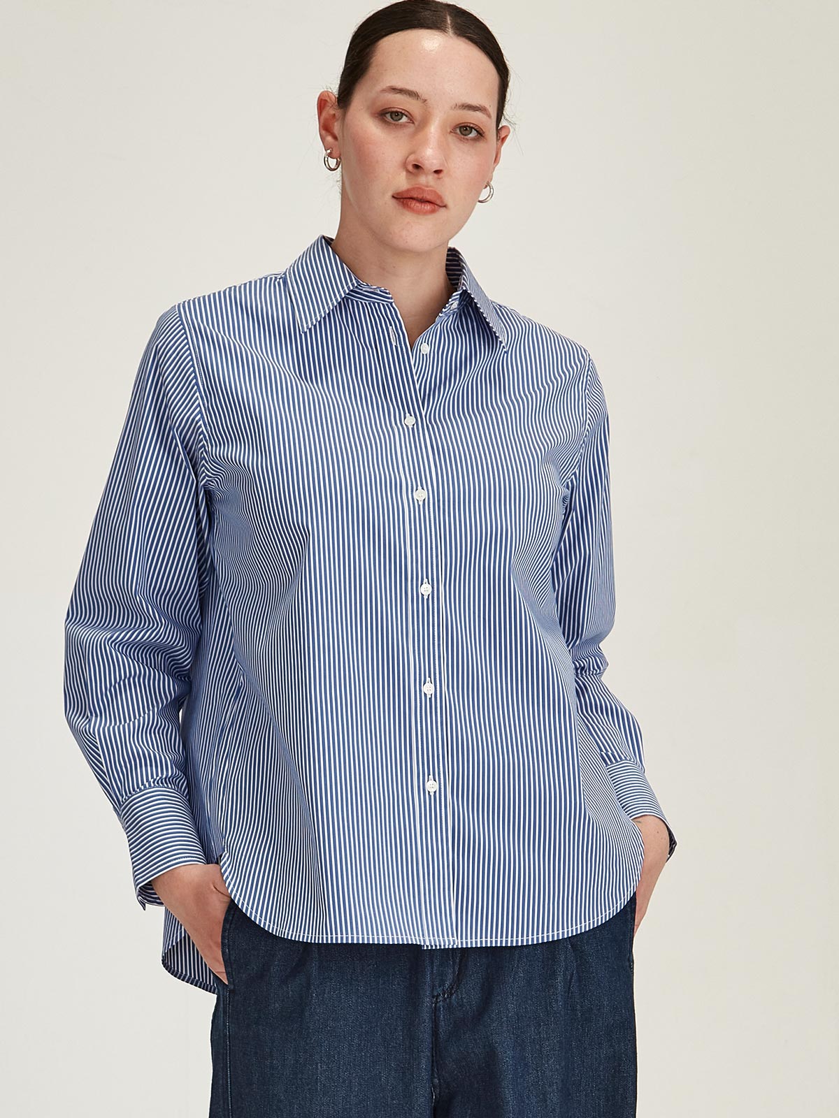 close up of woman wearing navy Sills Princeton Striped button up Shirt against grey background