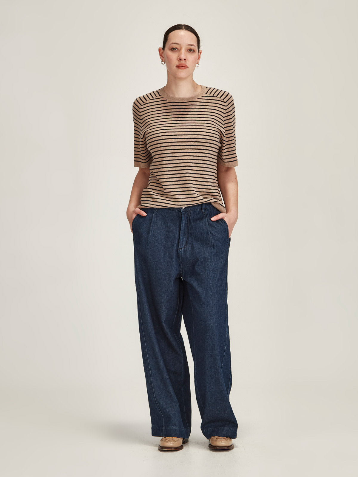 woman wearing Sills Cecilia striped knitted t-shirt and Britt wide leg dark denim jeans on grey background