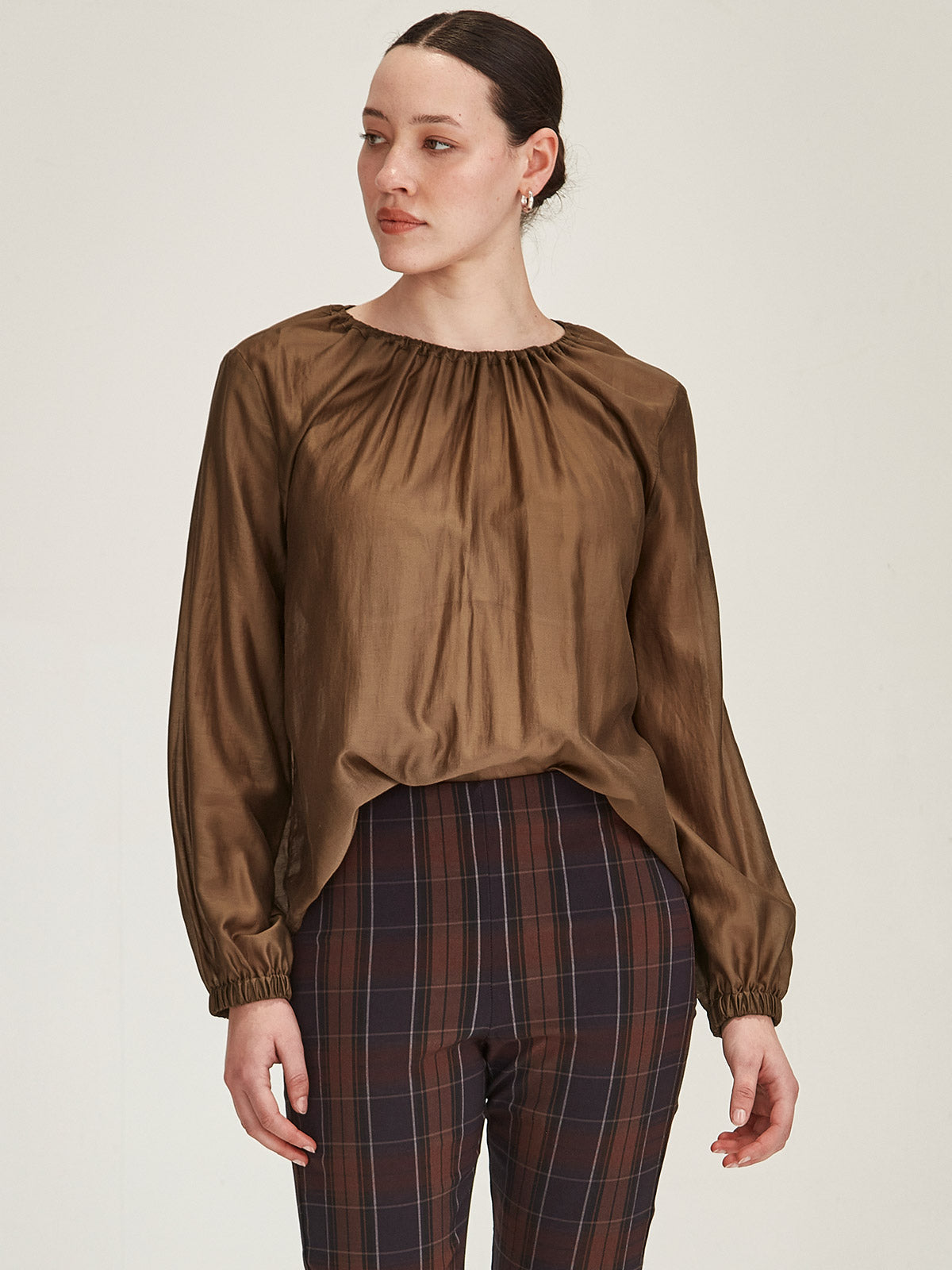 close up of woman wearing Sills Anna chiffon blouse Top in Cinnamon against grey background