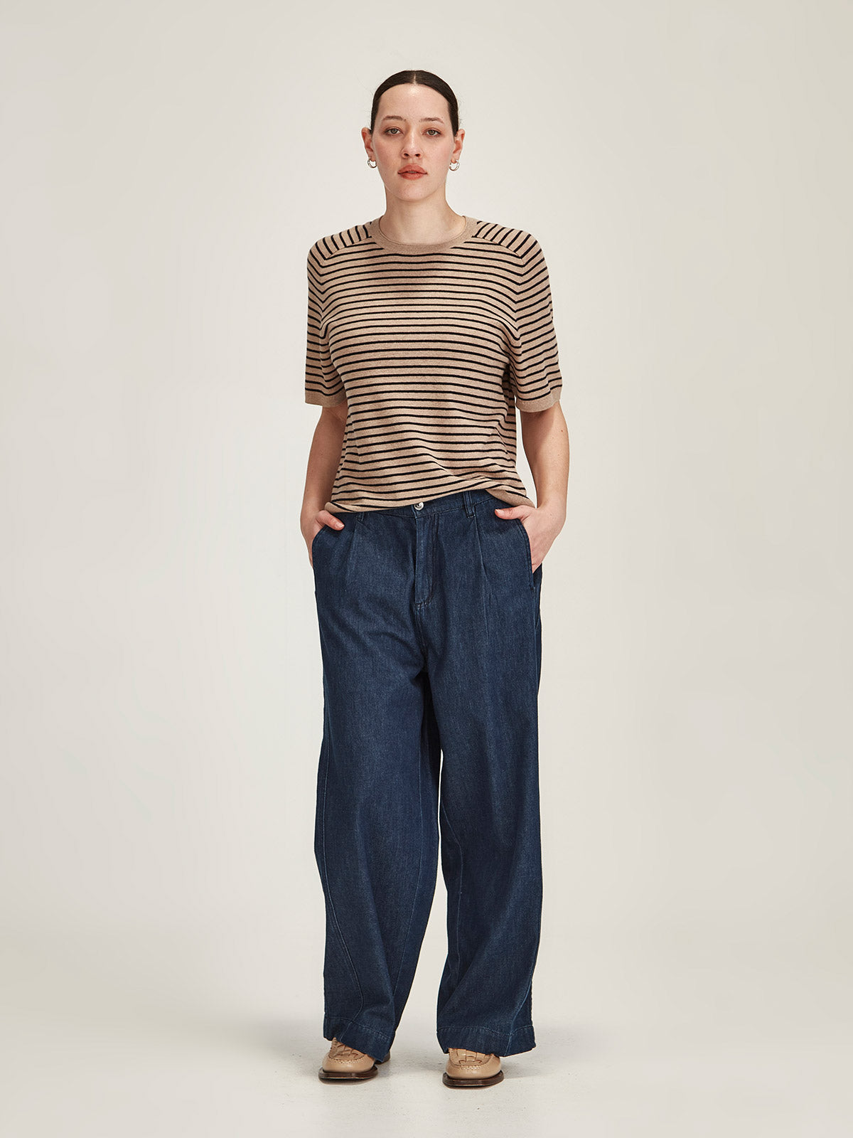 woman wearing Sills Cecilia striped knitted t-shirt and Britt wide leg dark denim jeans on grey background