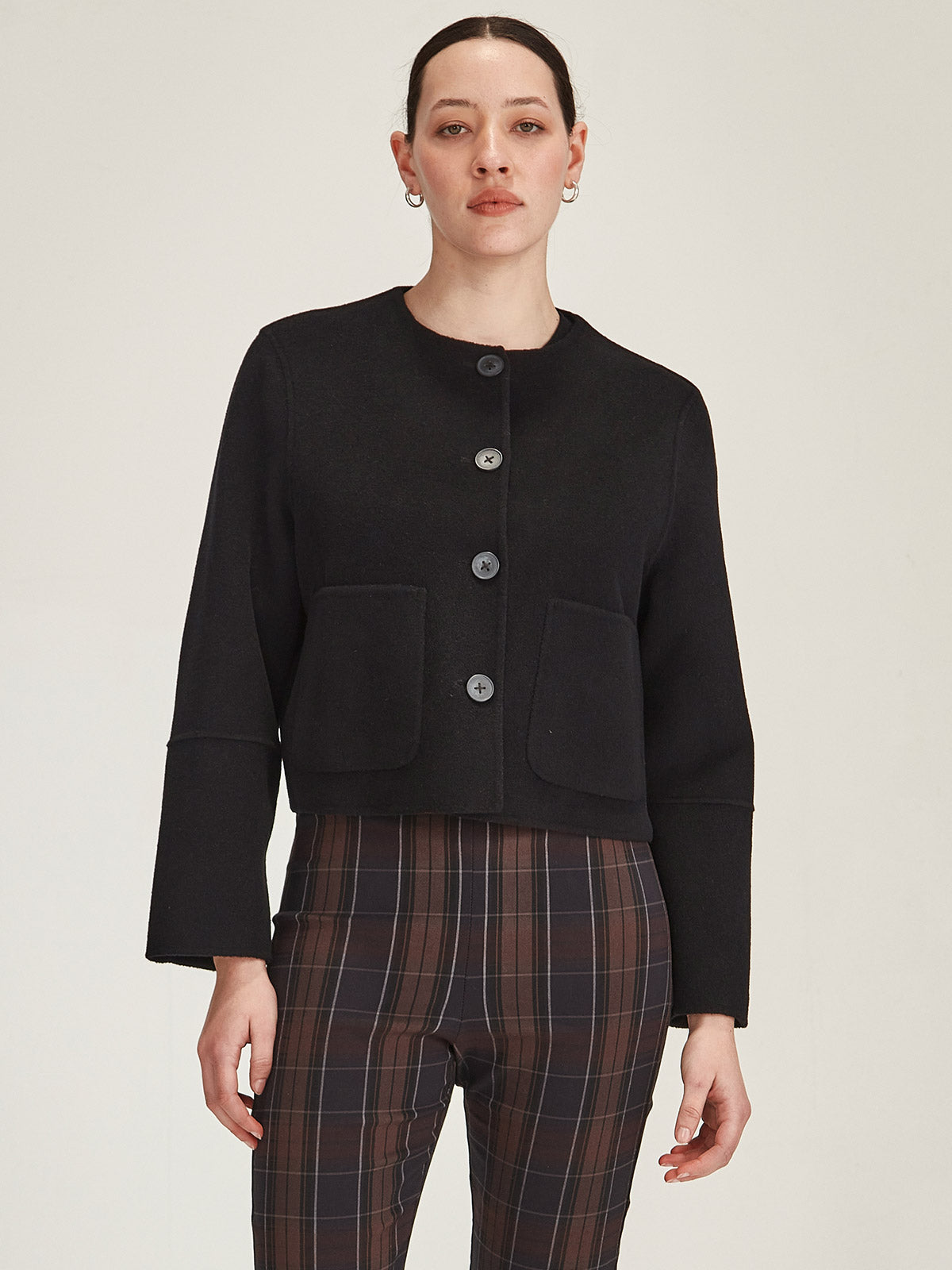 Close up of woman wearing Sills Black Emiko wool and cashmere blend collarless Jacket on grey background