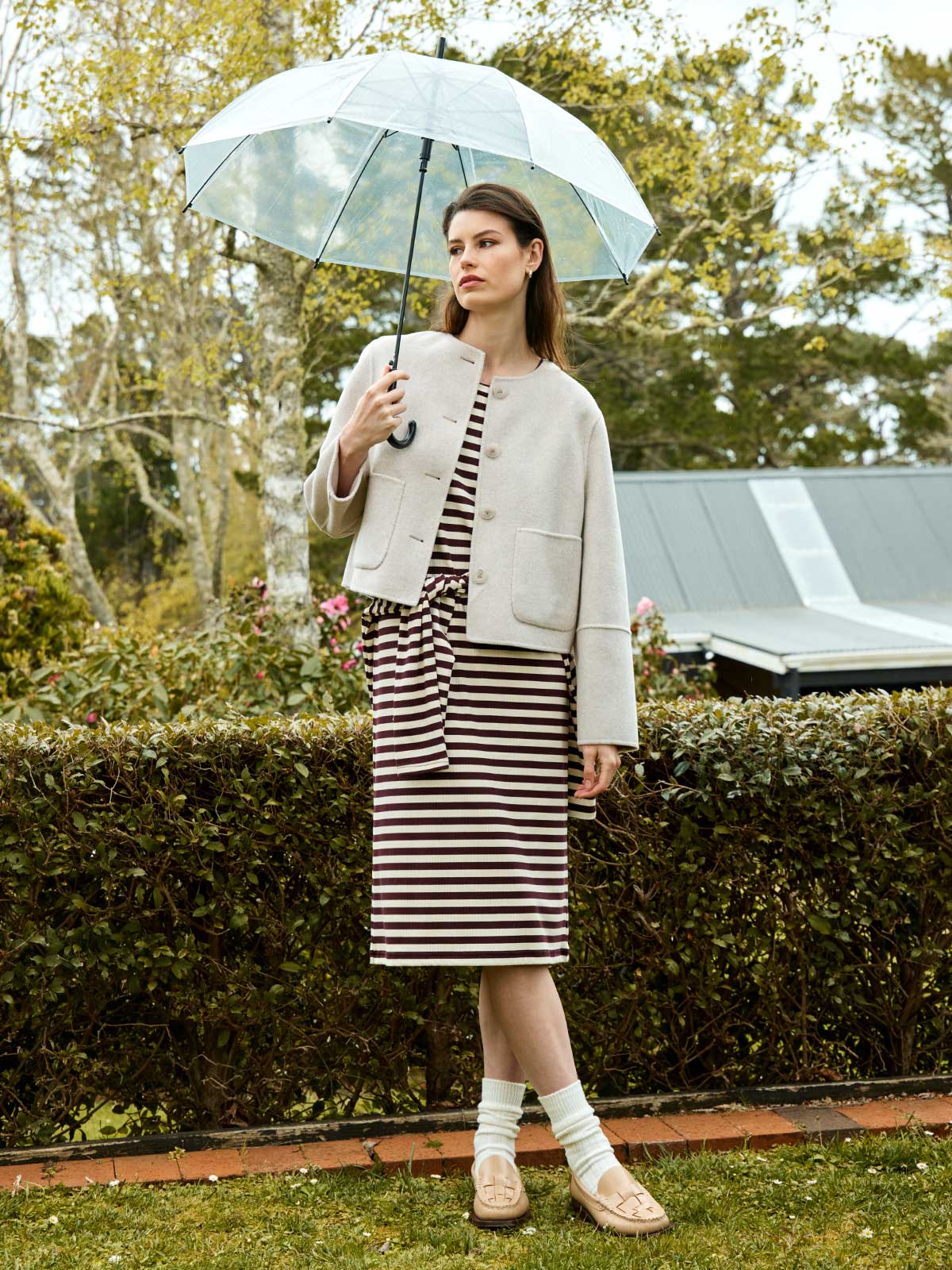 Woman outdoors wearing Sills Emiko wool and cashmere blend jacket in Perla over cocoa striped Gianna t-shirt dress