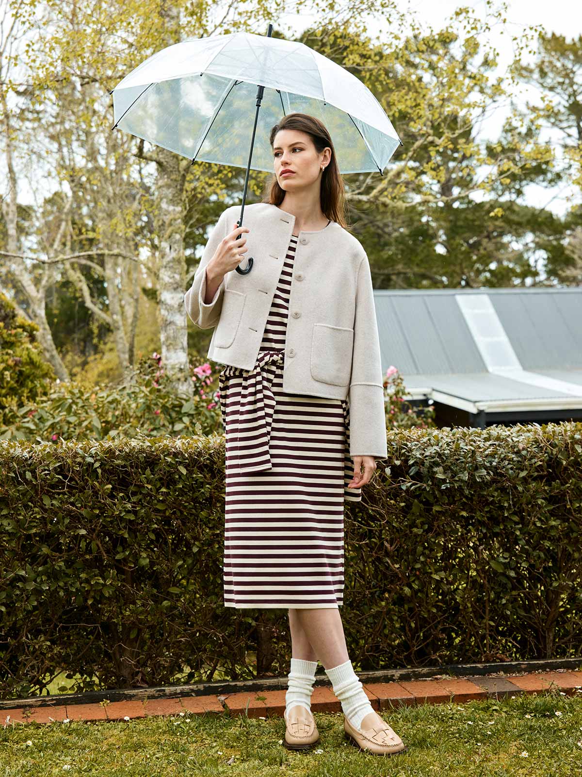 Woman outdoors wearing Sills Emiko wool and cashmere blend jacket in Perla over cocoa striped Gianna t-shirt dress