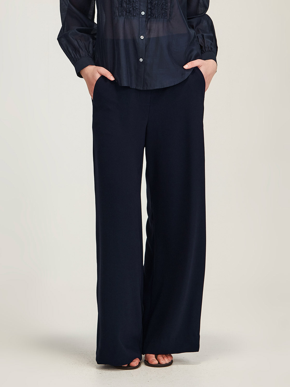 Close up of woman wearing Sills navy Luca Wide Leg joseph crepe Pant