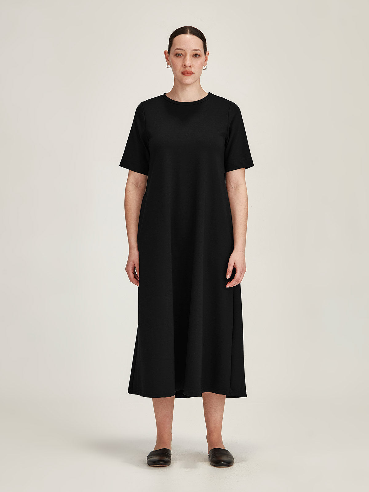 woman pictured against grey background wearing Sills black Tula Ponti du Jour t-shirt midi dress