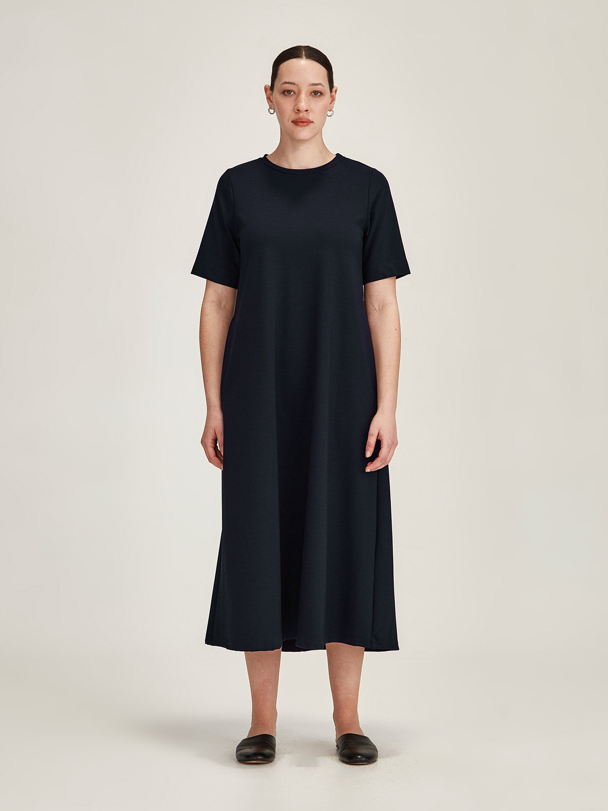 woman pictured against grey background wearing Sills french navy Tula Ponti du Jour t-shirt midi dress
