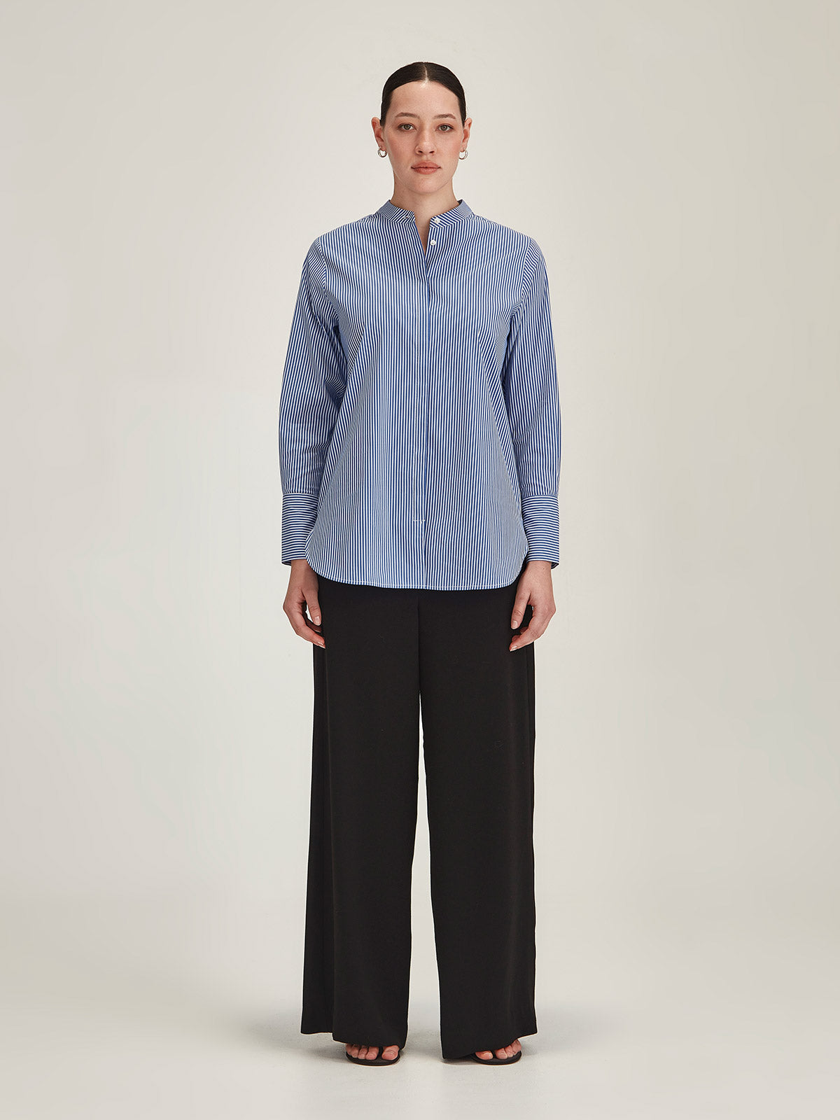 woman wearing Sills navy Koda Striped Shirt and navy Luca Wide Leg Pant on grey background