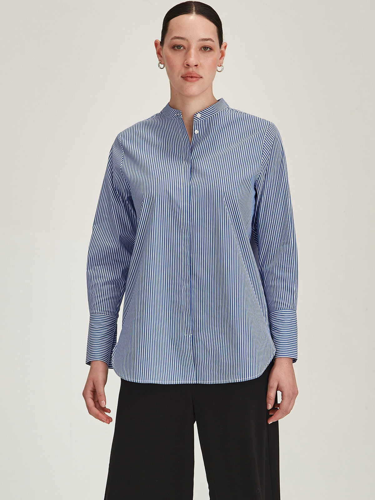 close up of woman wearing Sills navy Koda Striped Shirt on grey background