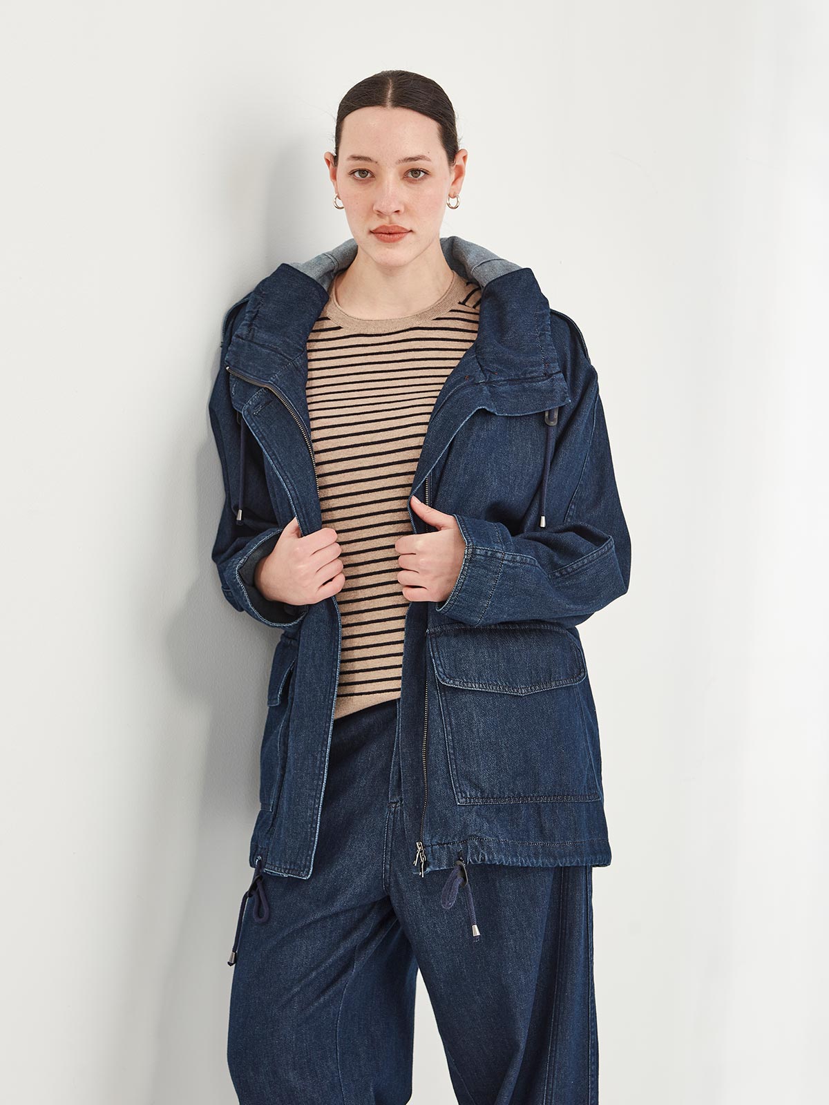 woman wearing Sills Dover denim hooded Parka jacket with Cecilia stripe knitted tee and dark denim jeans on white background