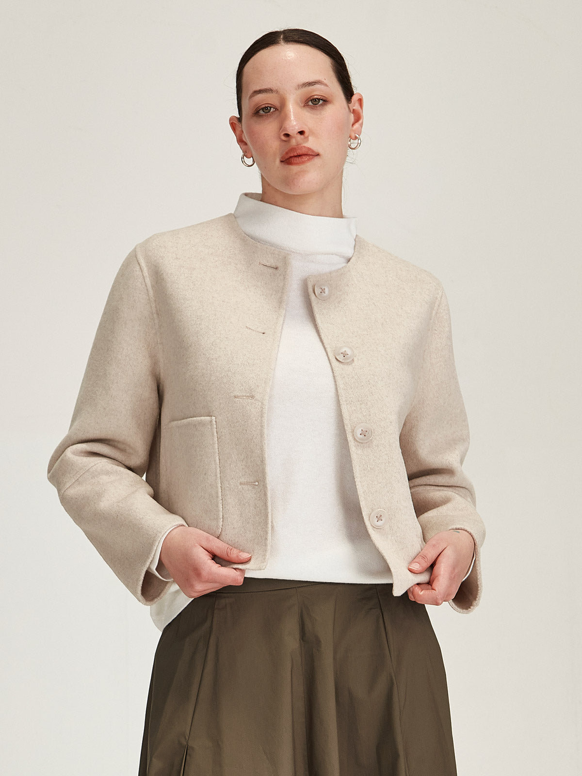 Close up of woman wearing Sills Pearla  Emiko wool and cashmere blend collarless Jacket on grey background
