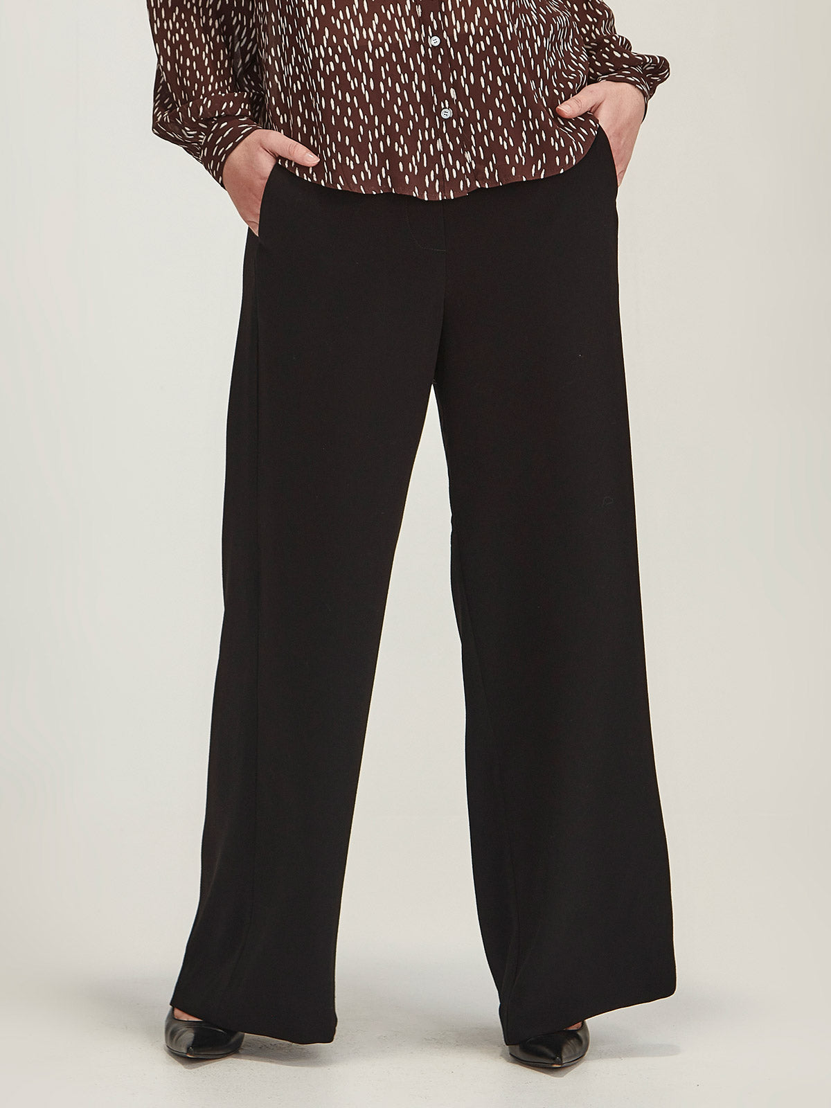 Close up of woman wearing Sills black Luca Wide Leg joseph crepe Pant 