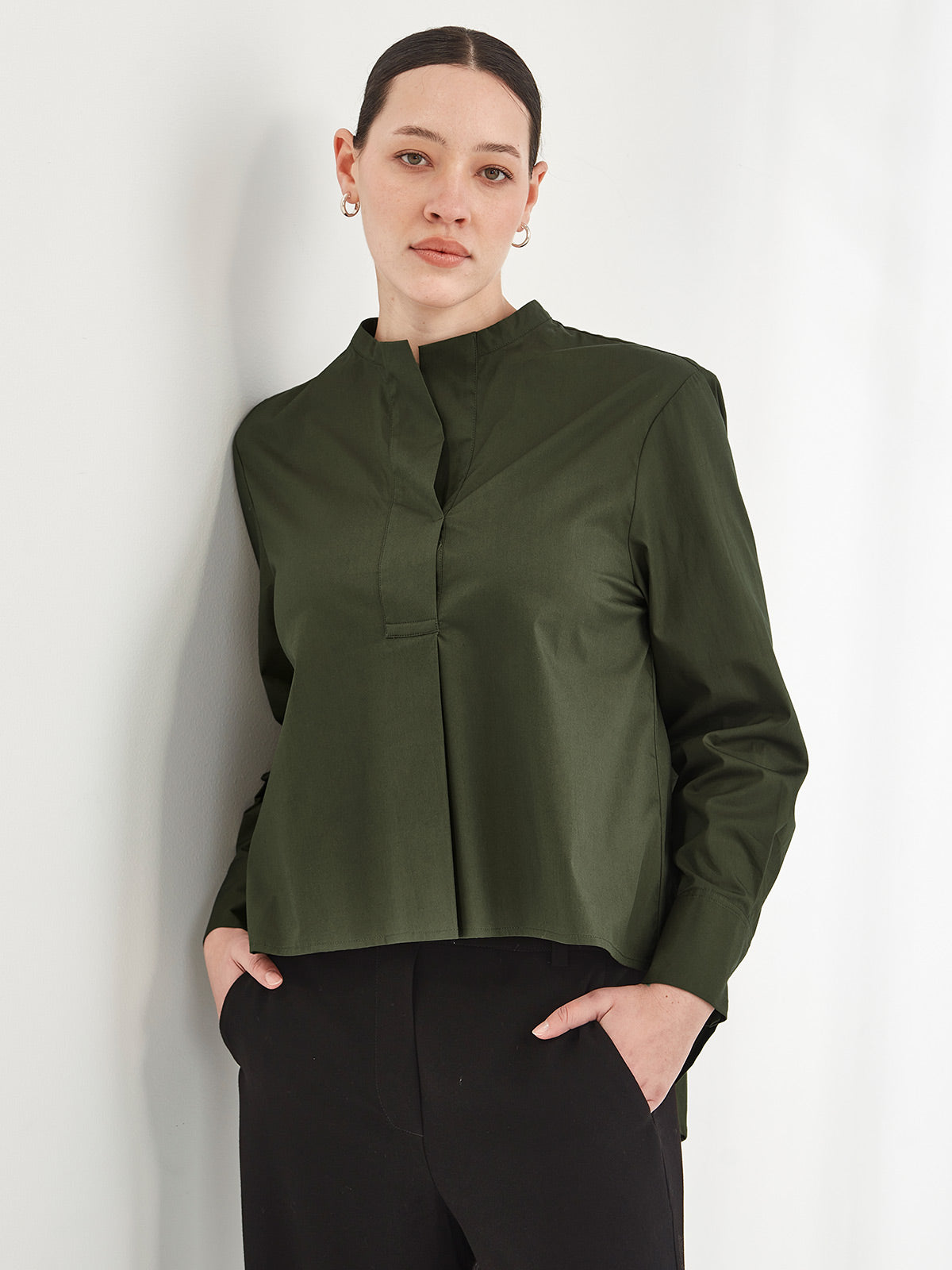 woman wearing Sills khaki Corso nehru collar swing shirt  on grey background