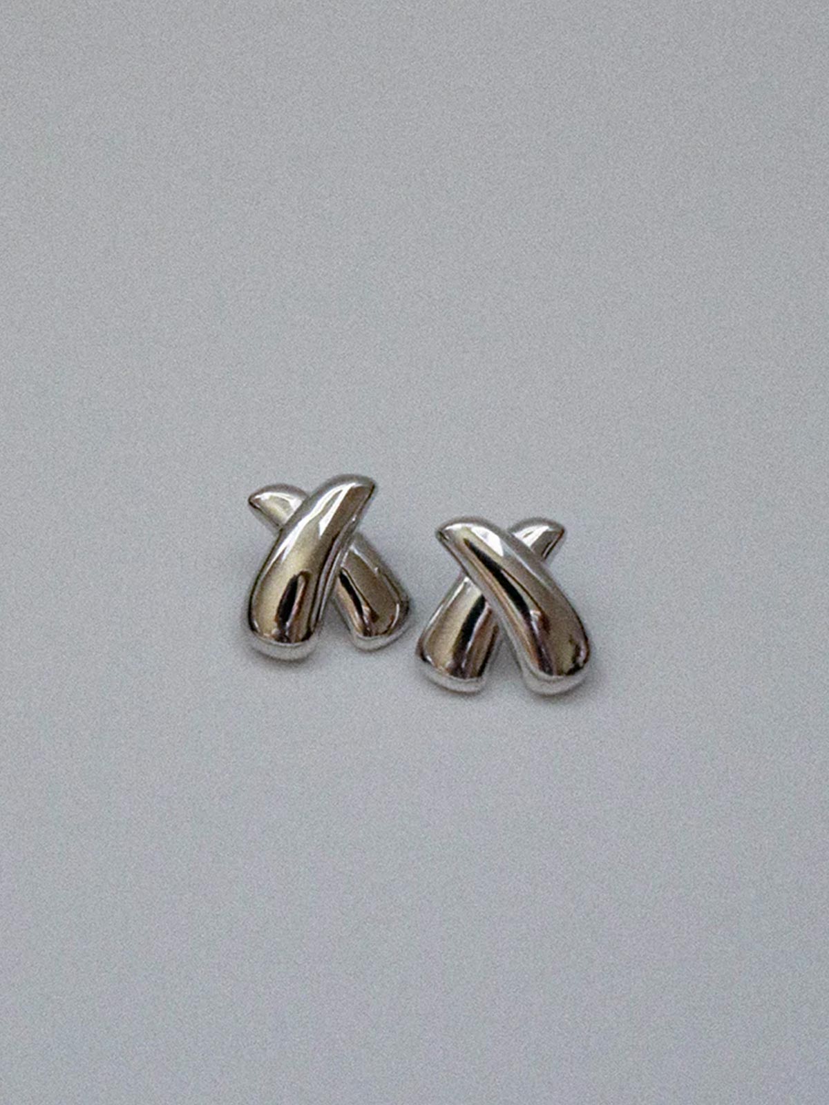 Zahar Piper silver earrings (Z270) shown from the front view in their sleek and polished “X” design, displaying the complete earring design with its polished stainless steel (nickel free) finish.