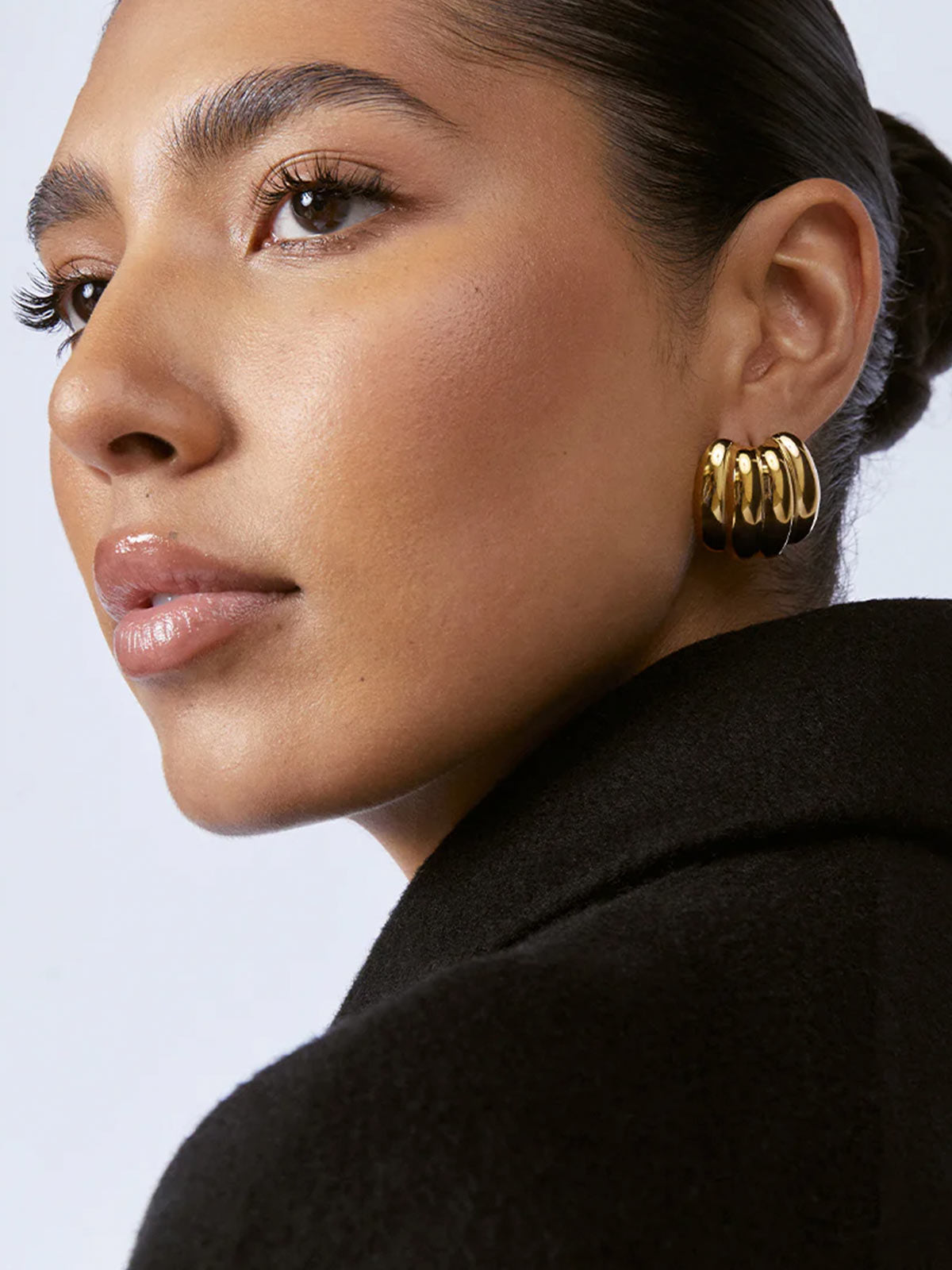 Zahar Bonnie gold earrings (Z276) shown from a side angle on a female model, highlighting the dimensional details and craftsmanship of the earring design.